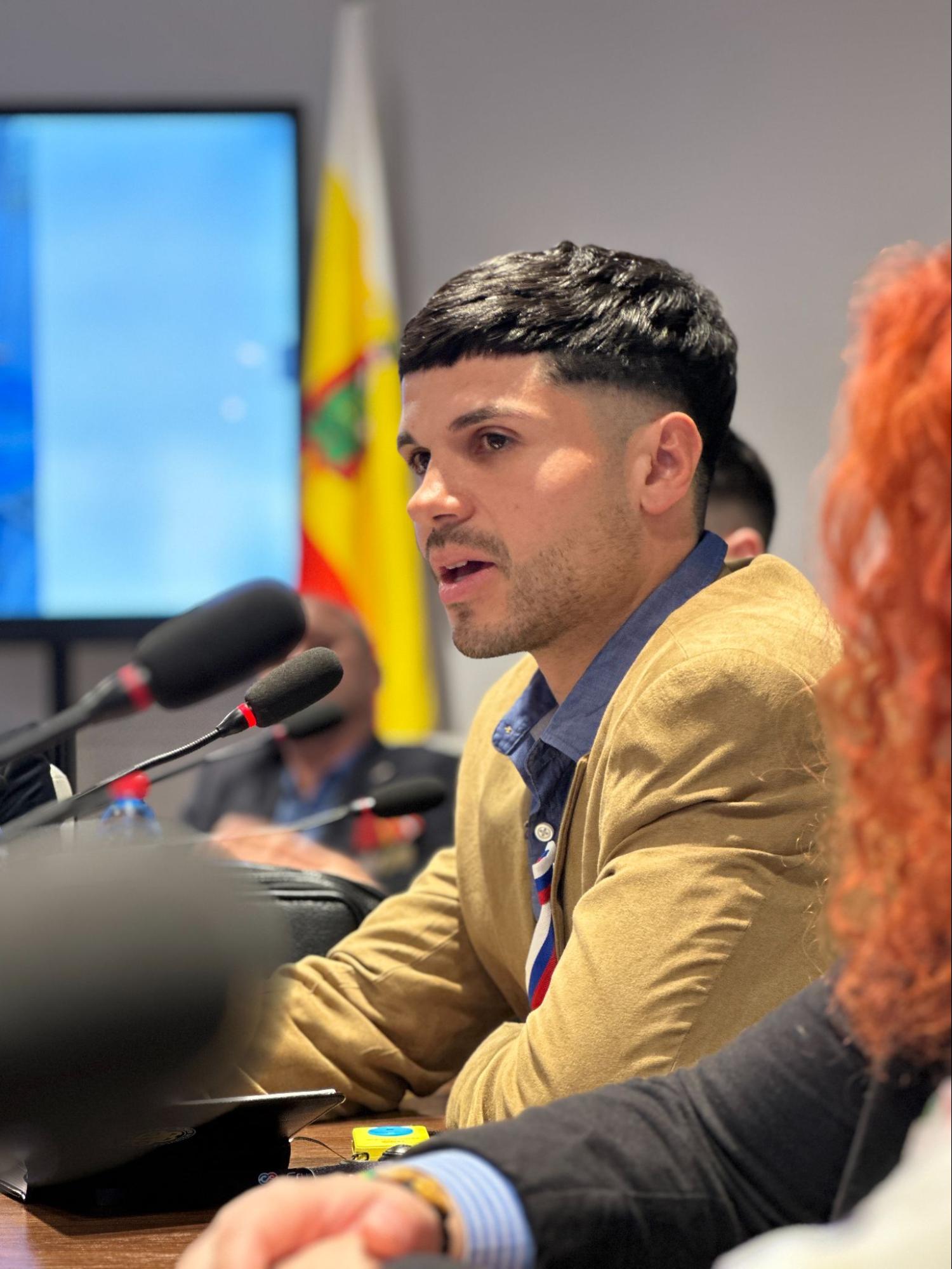 The author speaking into microphones during the meeting at the public observation headquarters.