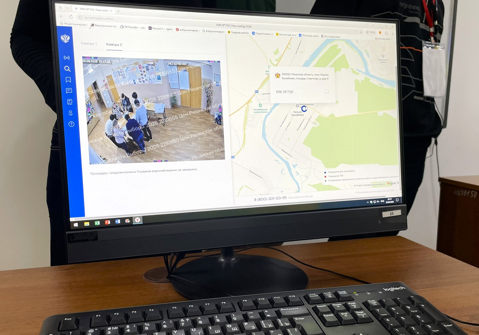 Photograph of a monitor displaying camera 2 of polling station No. 758 and its location on a map.