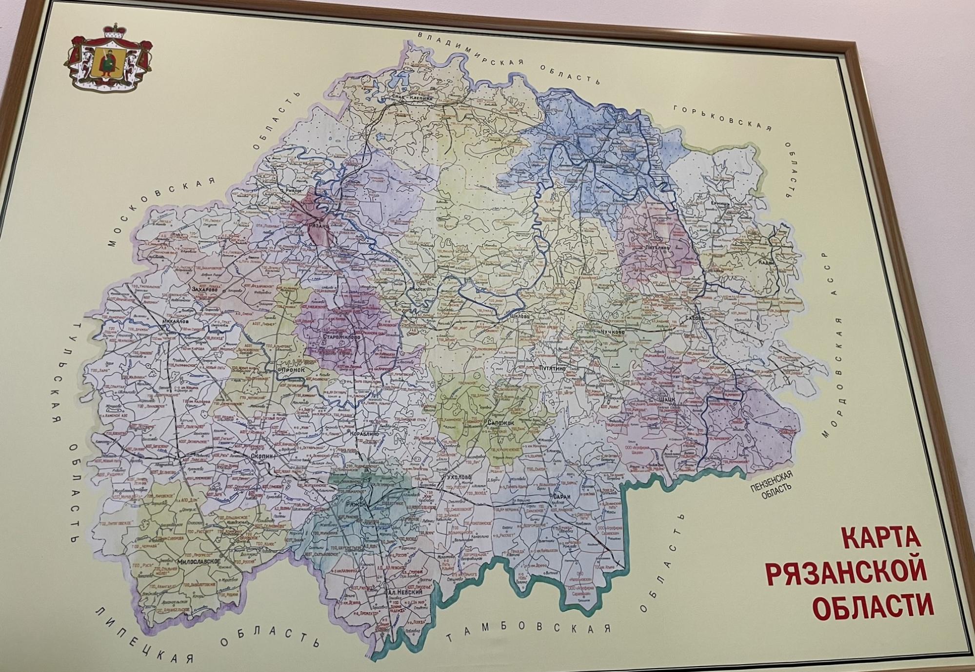 Photograph of a framed wall map of Ryazan Oblast, with a Russian-language caption.